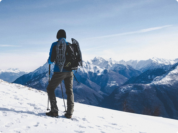 Person climbing in snowy mountains